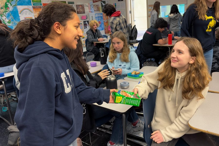Carlmont sophomore Asha Mehta, a Girl Scout, delivers cookies for the Girl Scout cookie sale. The fundraiser takes place from March 8 to April 23, and people can  choose from ten kinds of cookies to purchase.