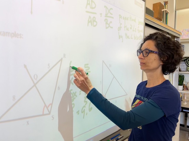 LeCuyer uses the smartboard as a visual aid to help students solve proportions. 
