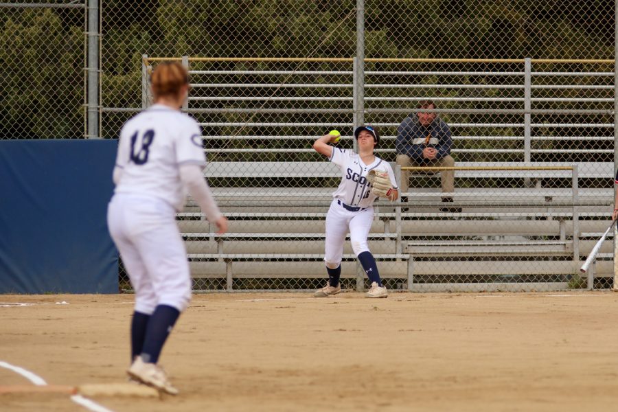 Junior Izzy McCandless throws the ball for an out at first base.
