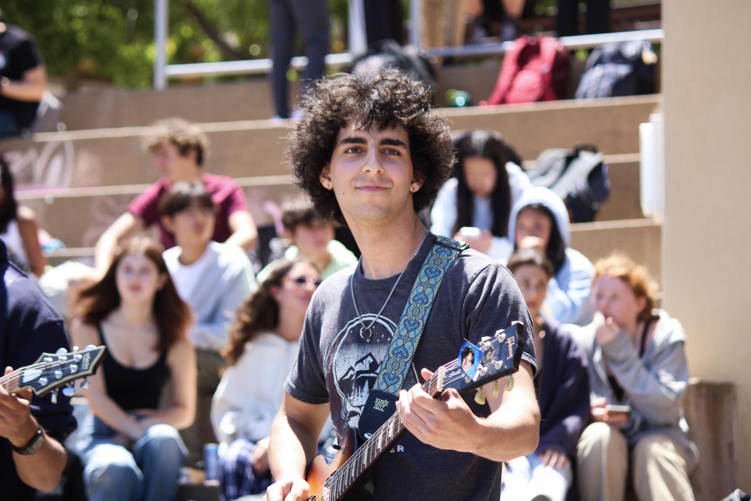 Ravi Hasan enjoys the moment as he performs music in the school quad.