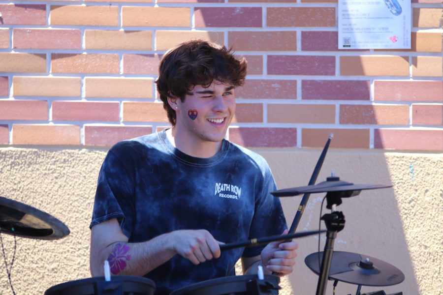 Senior and star drummer, Alex Maurry, winks at a friend during his bands live performance during Scotsland. 
