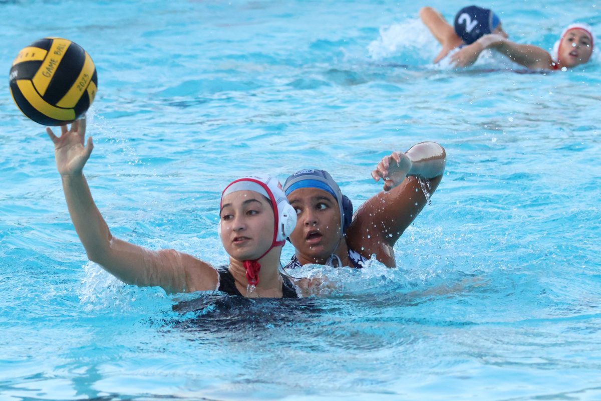 Sophomore Sanaa Bharadwaj puts high pressure on the opponent receiving a pass. When defending, players must avoid pushing each other down too far, as that may cause a foul to be called. In this case, Bharadwaj was able to pressure the player to pass back to her goalie, allowing the rest of the Scots to get back on defense.