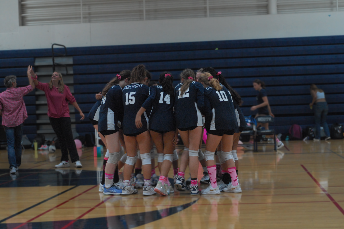 The Scots stand in a huddle before the game begins. We’re a very closely bonded team, said outside hitter Amber Lee.