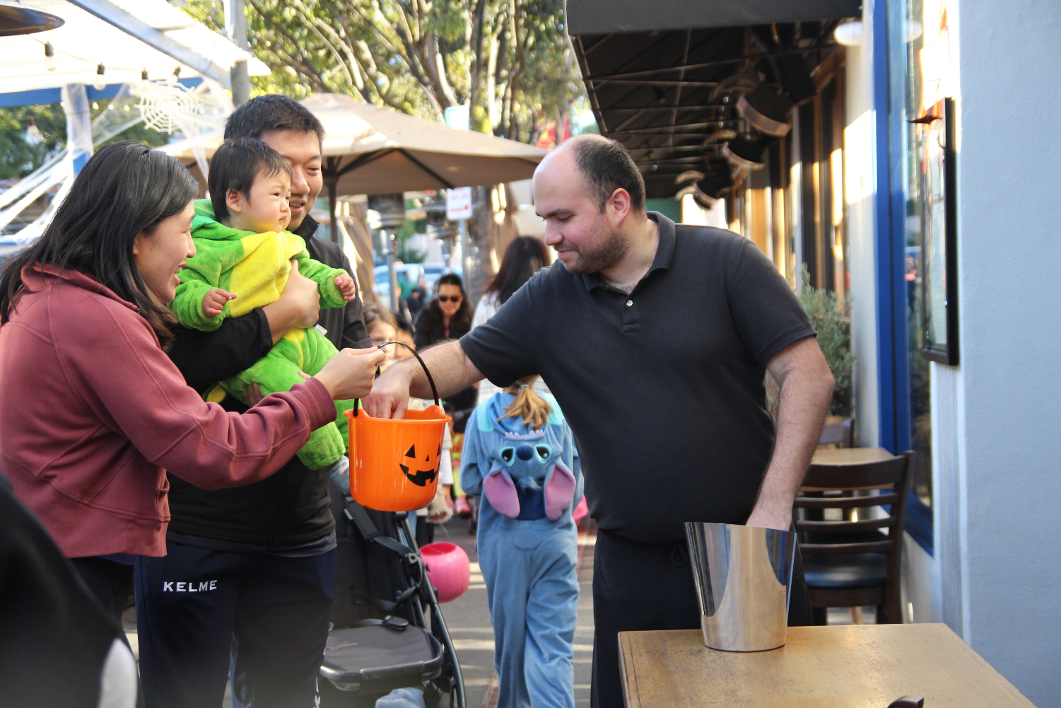 Families trickortreat down Laurel Street at the Goblin Walk Scot