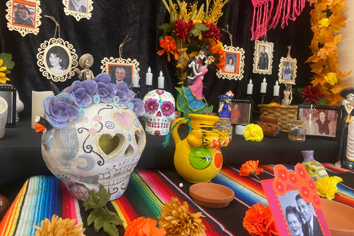 An+ofrenda+in+the+staff+lounge+is+decorated+for+D%C3%ADa+de+los+Muertos.+Common+decorations+for+ofrenda+altars+include+colorful+skulls%2C+flowers%2C+candles%2C+and+pictures+of+loved+ones.