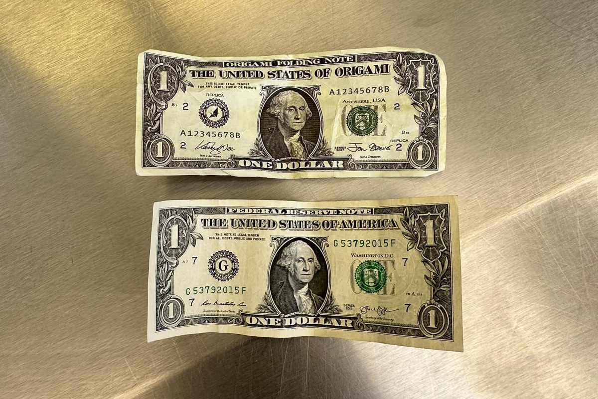 A side by side comparison of a real U.S. dollar to a counterfeit one (the counterfeit is shown on top of the authentic) shows how easily one could be mistaken for the other. The similarities led the counterfeit bill to pass as the authentic one for snacks at the student store. 