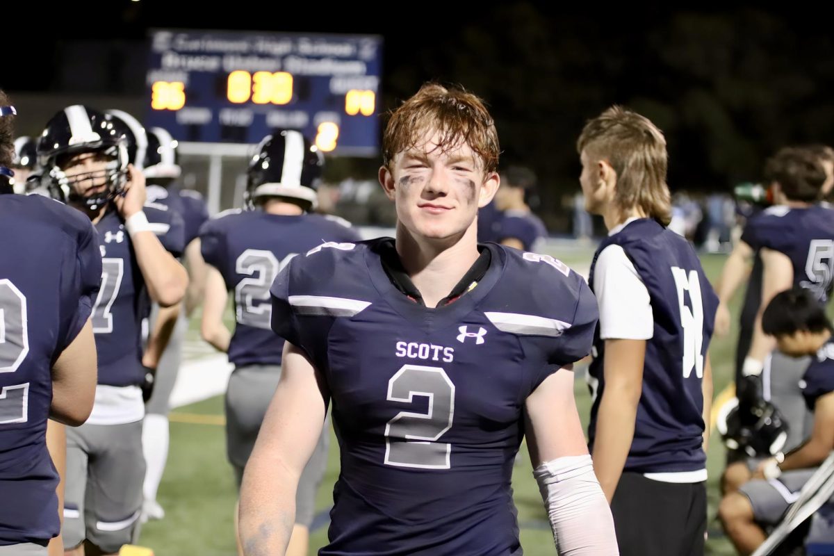 Senior running back Braeden Kumer rests on the sidelines after scoring a touchdown in the third quarter. Kumer rushed for 331 yards and got four touchdowns, making it a victorious night for him. “I love my offensive line,” Kumer said. 