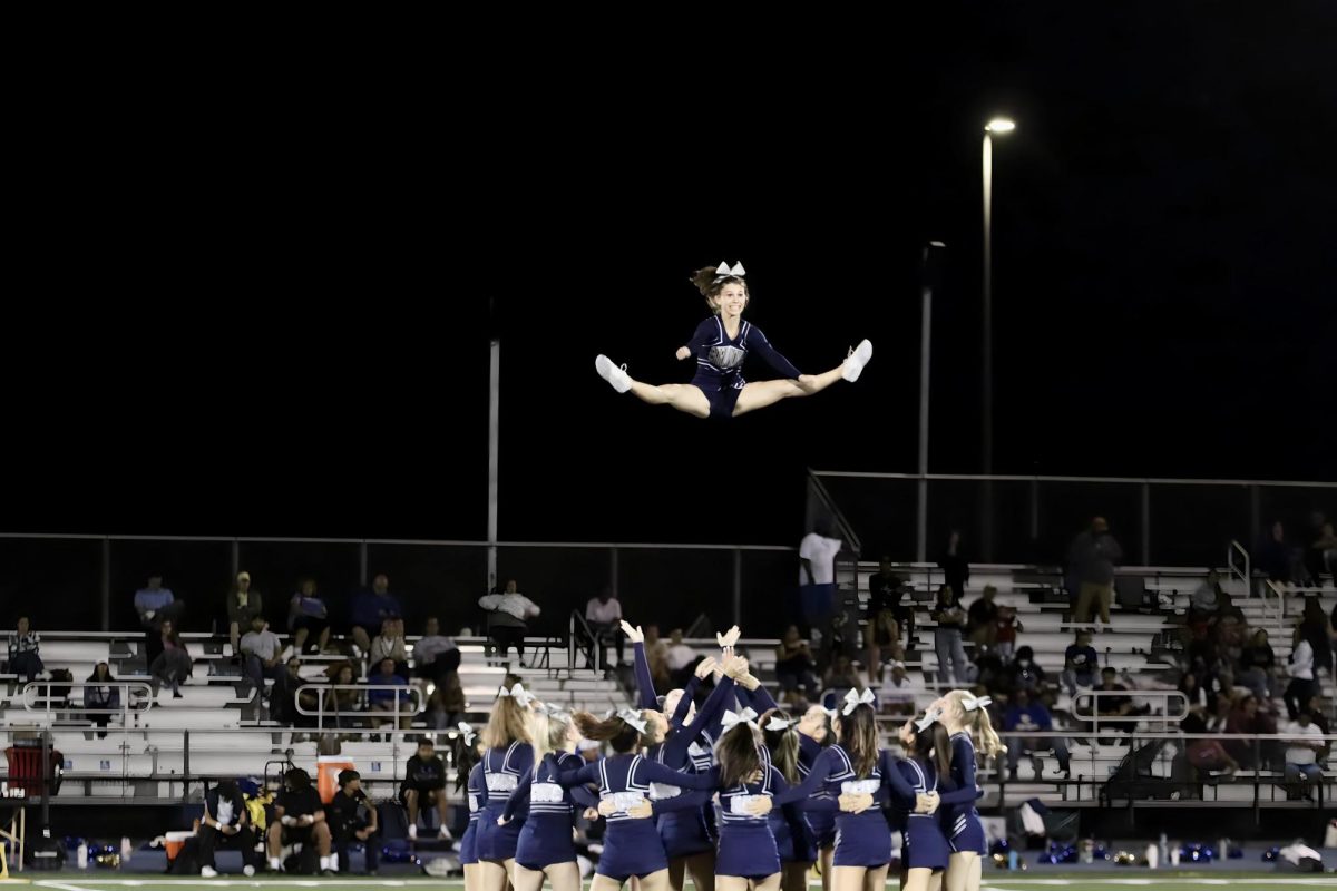 The Carlmont cheer team dazzles the crowd during halftime with their high-flying routine. Senior flyer Sarah Shalita remarked on their performance. “Our routine went very smoothly and it was one of the best games I think we’ve performed at, Shalita said. 