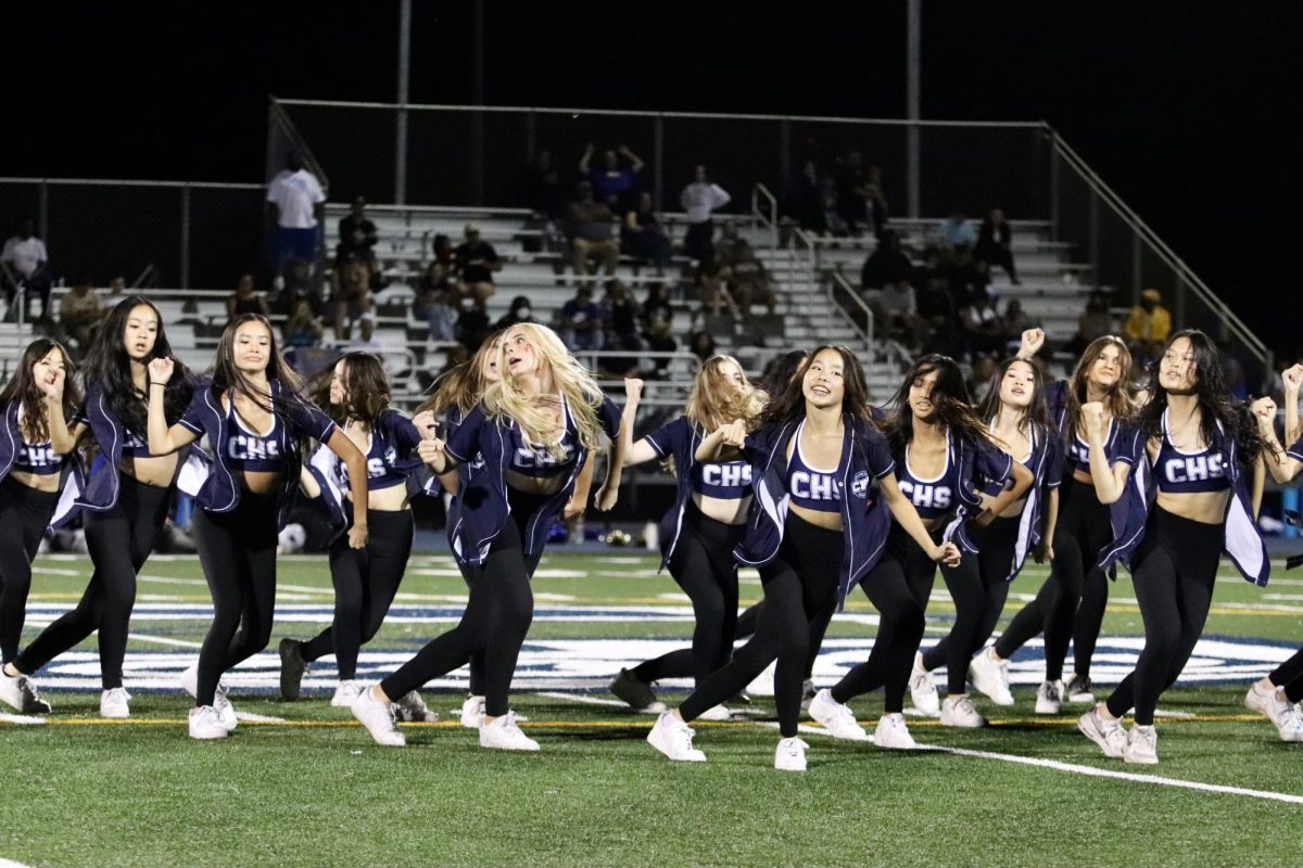 The Carlmont dance team performs their routine at halftime. Junior Alissa Zirelli and sophomore Ashlynn Son lead in front. The audience cheered loudly for their compelling performance. 