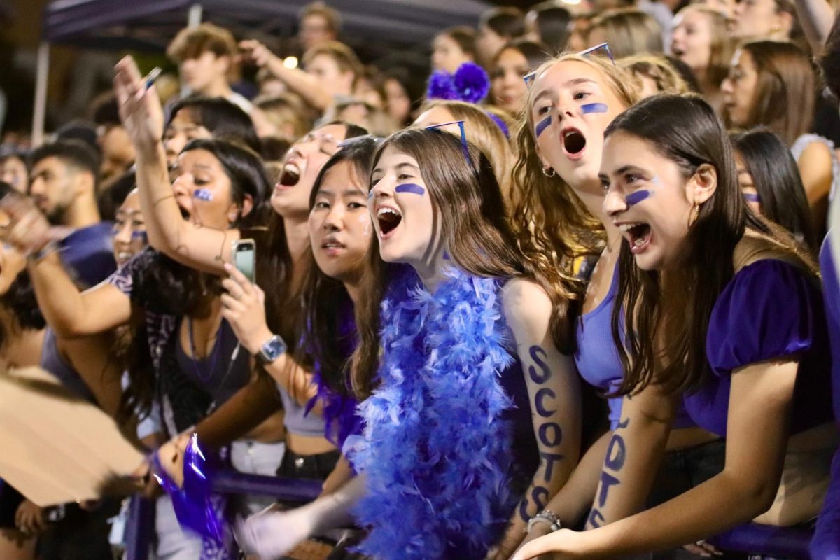 Senior Paige Mayo and her friends chant in support of the Scots. “The football games are so fun to be at. We always cheer our hearts out and try to be as spirited as possible,” Mayo said. 