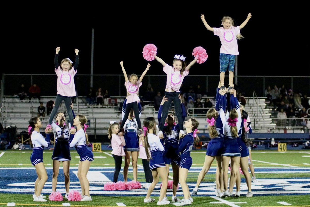 The cheer team brings a surprise guest out for their halftime performance: Mini Montys, a group of young cheerleaders from the community. Third grader Cecile Rotner shared her enthusiasm. I like flying and doing the cheers a lot. 
