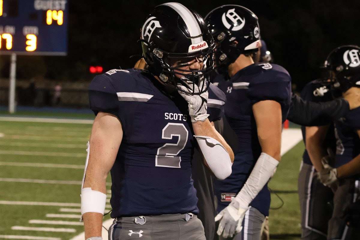 Senior running back Braeden Kumer takes off his helmet and mouth guard after scoring the second touchdown for the Scots in the first quarter. The Scots take the lead with a score of 15-14. 