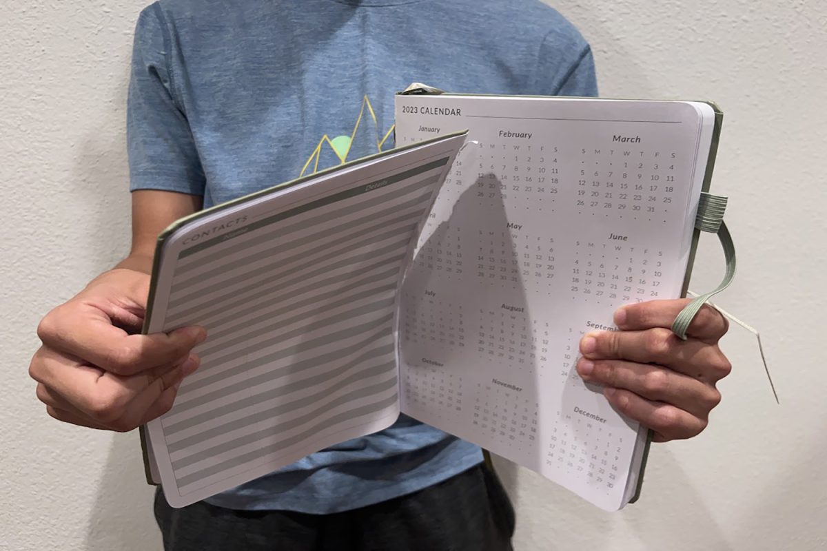 Sophomore Nico Golomb rips calendar in protest of Carlmonts scheduling decisions. “I feel like the administration isn’t really thinking about how big the effect of the schedule is on the students,” Golomb said.