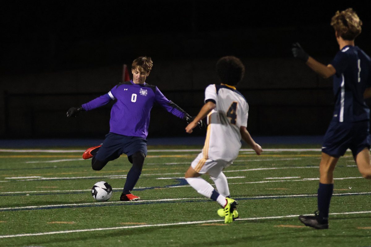 An incoming defender forces Carlmont goalie, Colin Edwards, to kick the ball up the field. Edwards is a junior and one of the captains of the JV team. He not only shows composure in his position but also in his leadership.