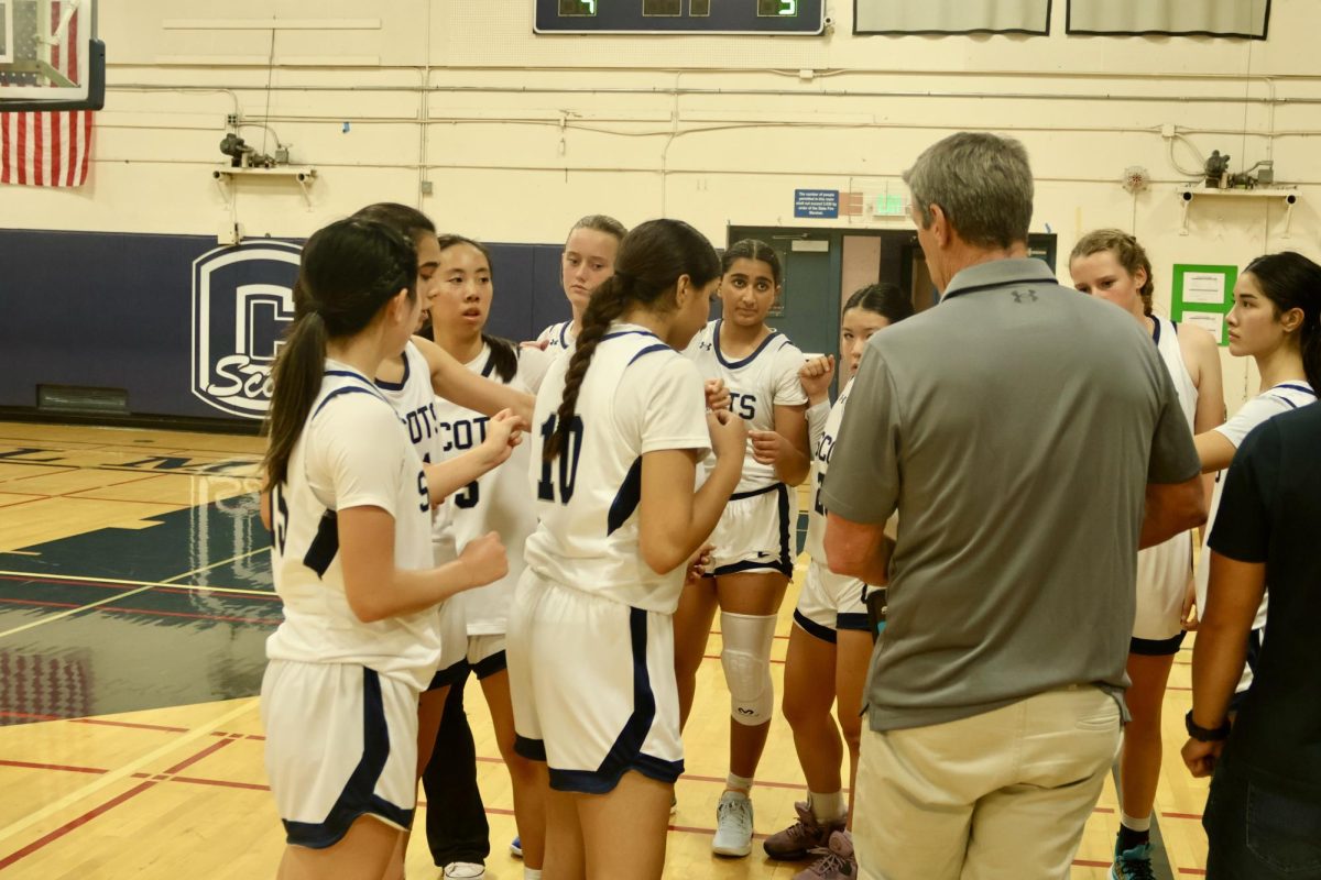 The Scots huddle during a timeout in the fourth quarter. Tensions were rising for the Scots as the Notre Dame Tigers began to catch up in score. Despite this, the Scots remained in good spirits as they returned to the court. 