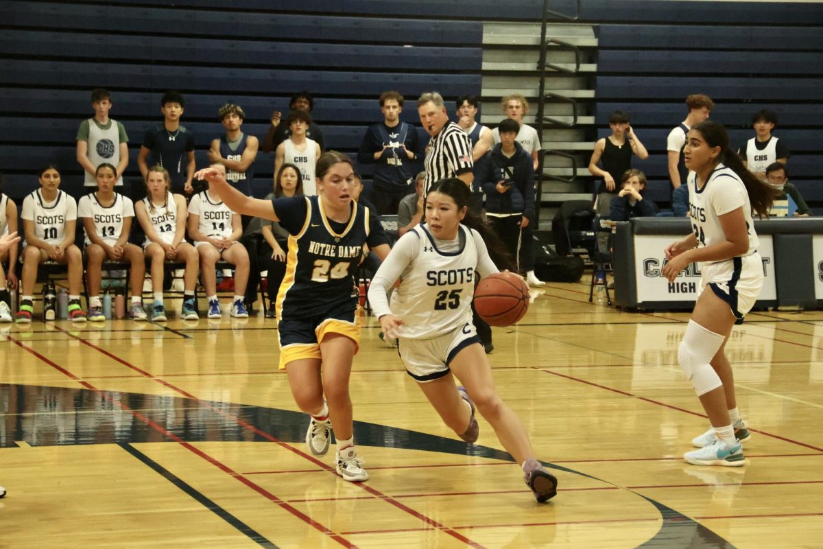 Willow Ishibashi-To makes a strategic move on the court to avoid the opposing team in the third quarter. Ishibashi-To is a junior point guard. Point guards try to steal the ball and are usually one of the teams best dribblers and passers. 