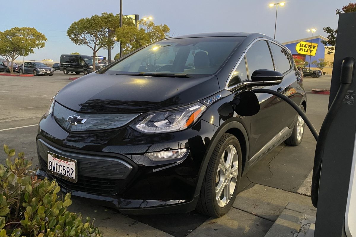 A Chevrolet Bolt,  the first long-range, mass-produced electric vehicles, being charged by an in home charger. 
