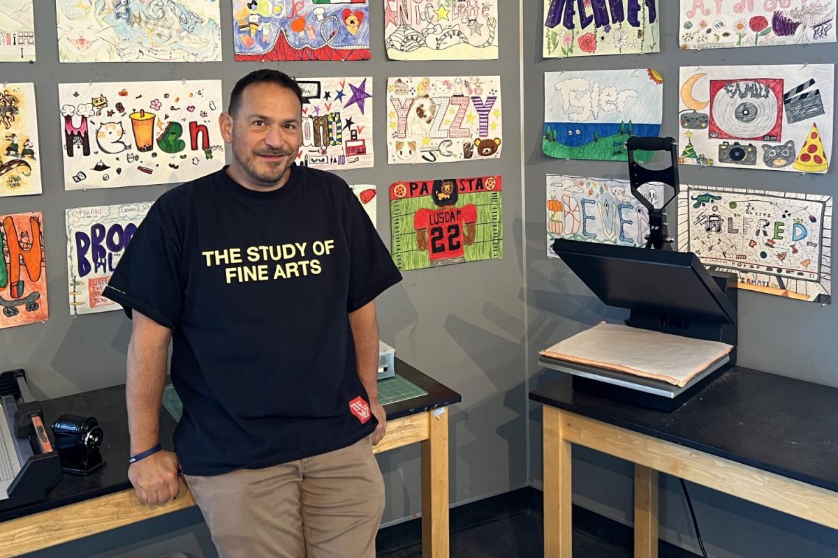 Joseph Espinosa in his classroom surrounded by his students art. The rewarding thing about teaching art is that you get to see somebodys creativity, and thats a blessing, Espinosa said.