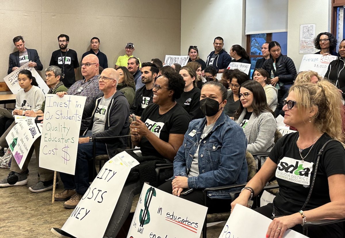 Teachers at the Oct. 25 board meeting express their support for salary raises with signs and SDTA shirts. Salary raises address the growing costs of living in the Bay Area and the discrepancies between SUHSD and other districts. In addition, they also help teachers with retirement funding.