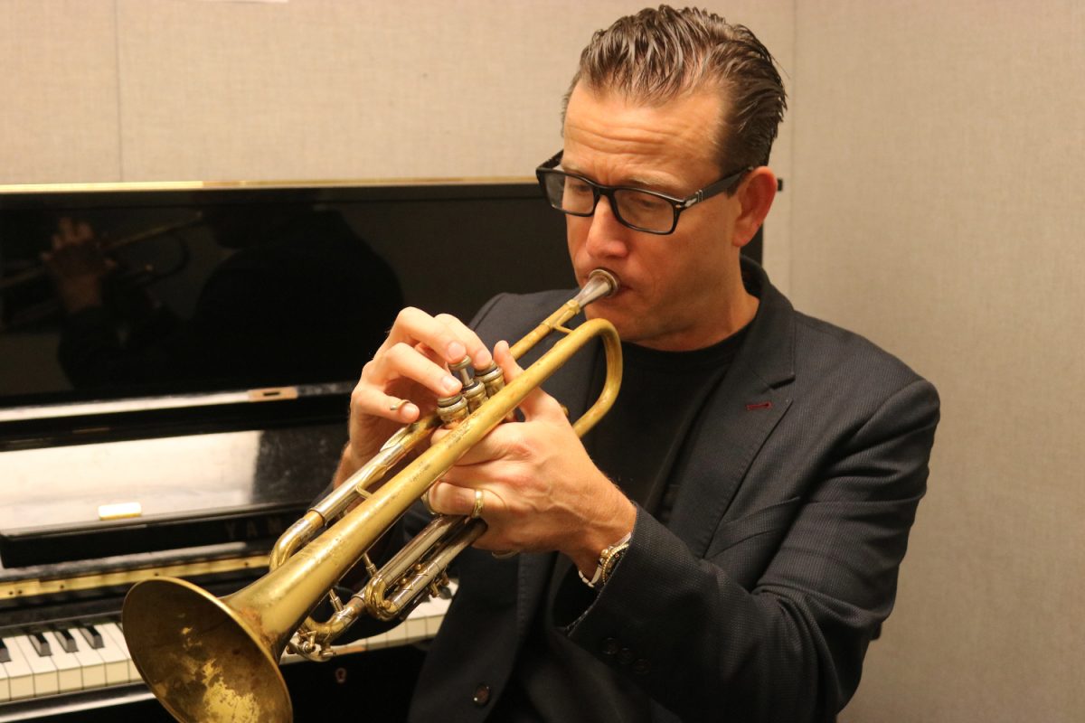 Brian Switzer warms up in a practice room, ready to teach a class. Switzer often showcases his abilities to the various performing groups he teaches daily.