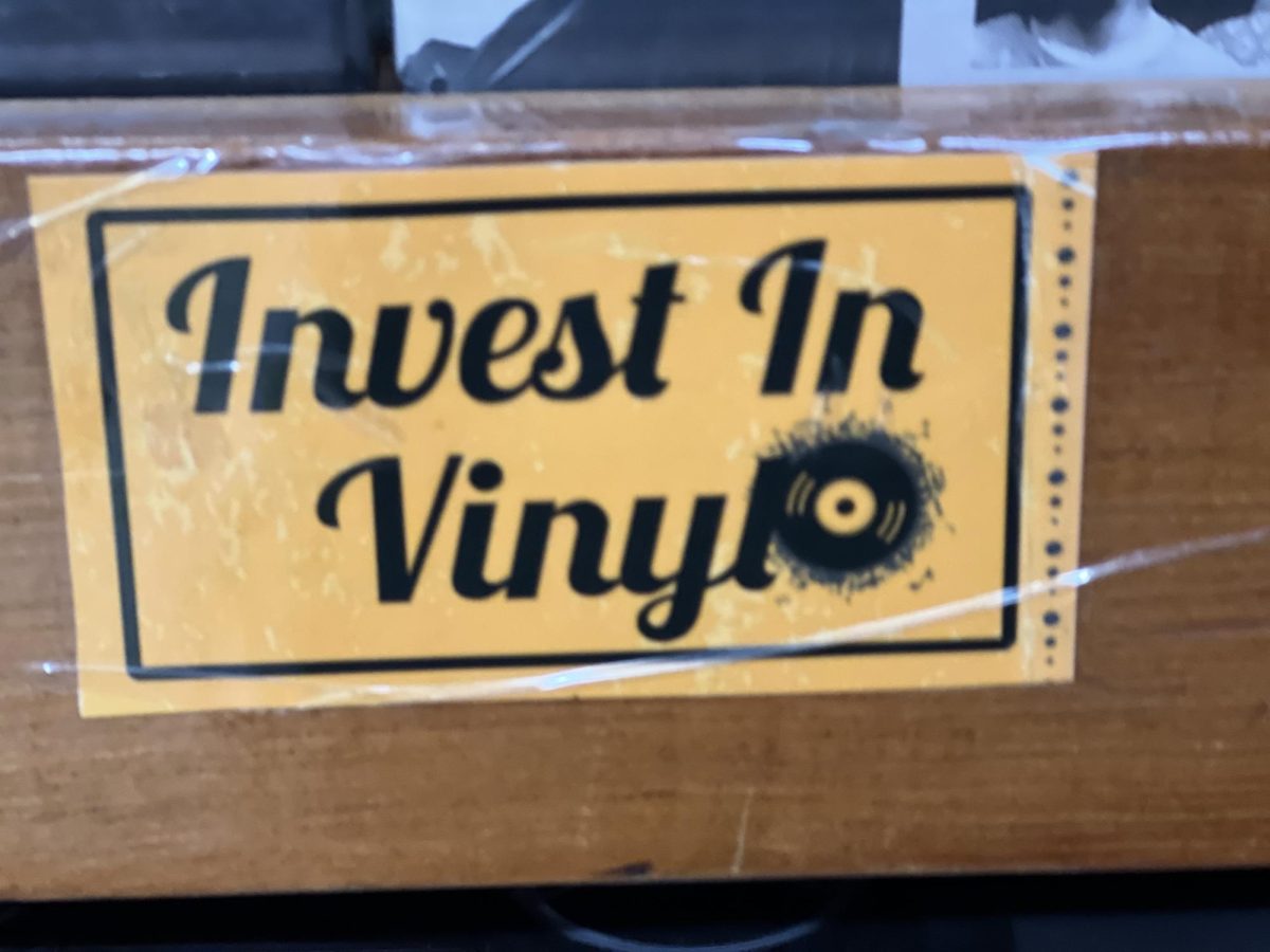 Sign inside of Vinyl Solution Records in San Mateo encouraging people to buy vinyl.