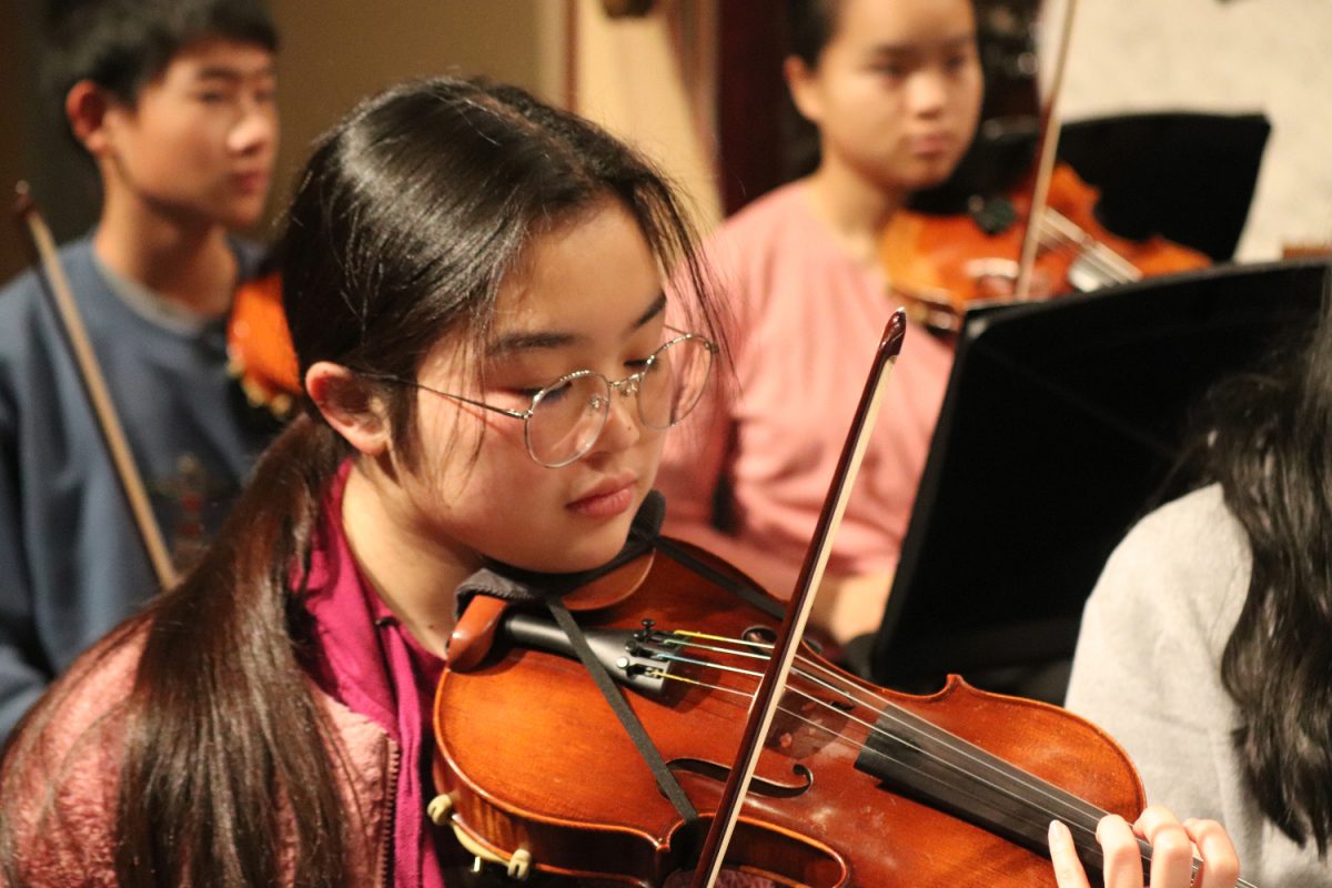 Emi Ota, a sophomore in Carlmont Instrumental Music, plays the violin. Ota is a member of the Symphony Orchestra, which performed various pieces on the second day of the Carlmont Instrumental Music Winter Concert. 