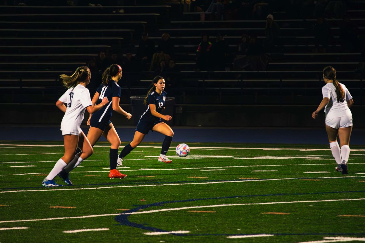 Freshman+forward+Gianna+Armanini+dribbles+the+ball+up+towards+the+opponents+goal%2C+scoring+a+point+for+the+Scots+in+the+second+half.+This+goal+was+1+of+4+goals+scored+by+the+Scots+in+the+second+half.
