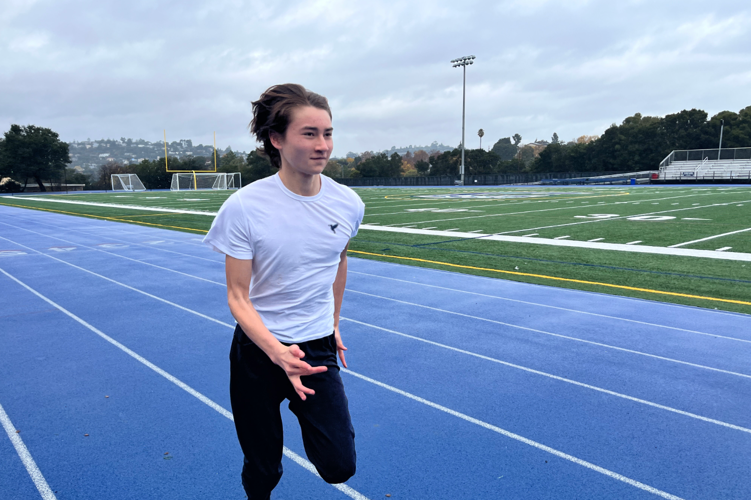 Carlmont Sophomore Dylan Holodya sprints across the track to prepare himself for the upcoming track season. Despite the rainy weather, Holoyda remains consistent throughout the off-season as a track athlete.