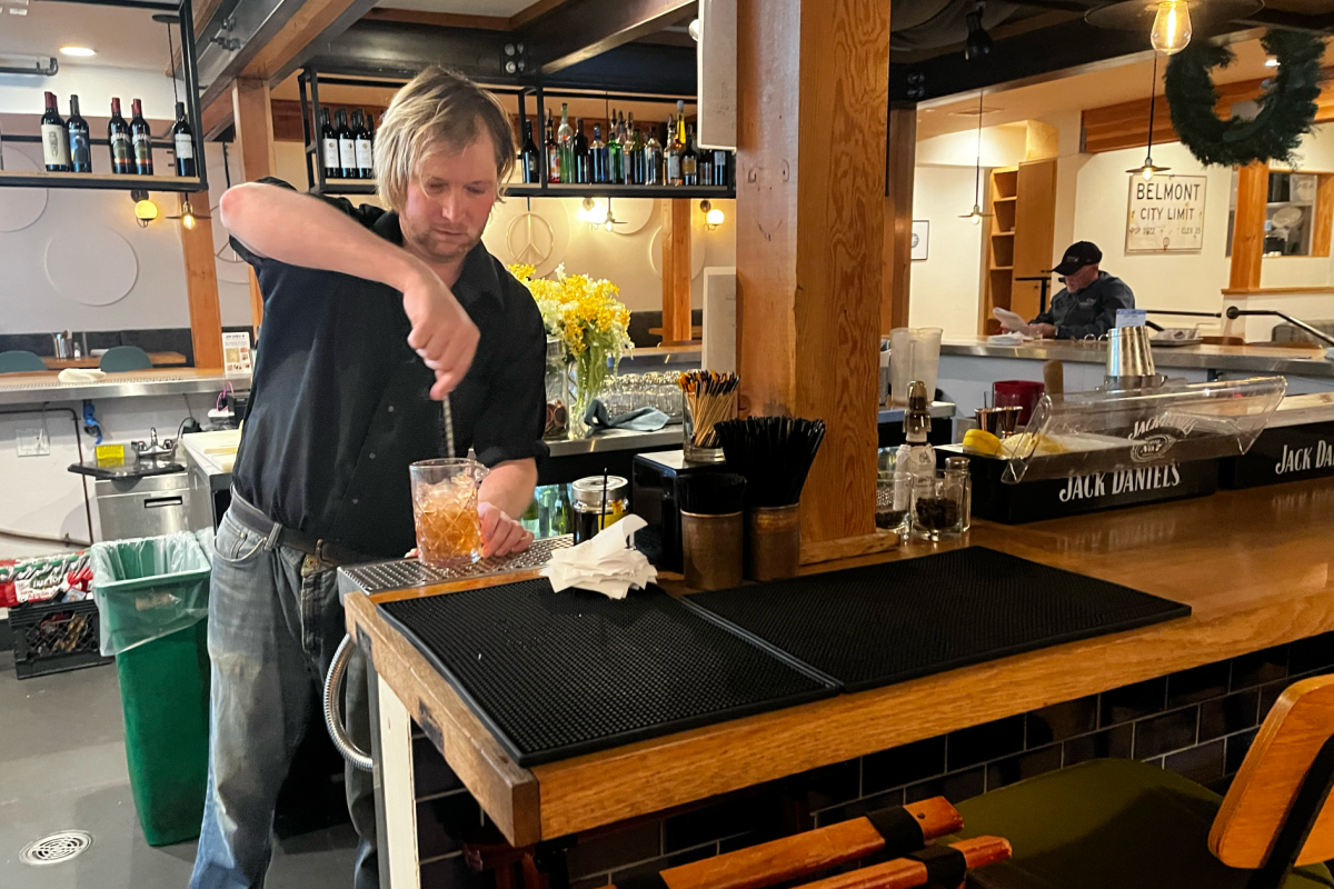 Justin, the front-of-house manager at Jim Burgs, mixes a drink. The restaurant, formerly called Waterdog Tavern, has reopened under new management at the Carlmont Shopping Center.