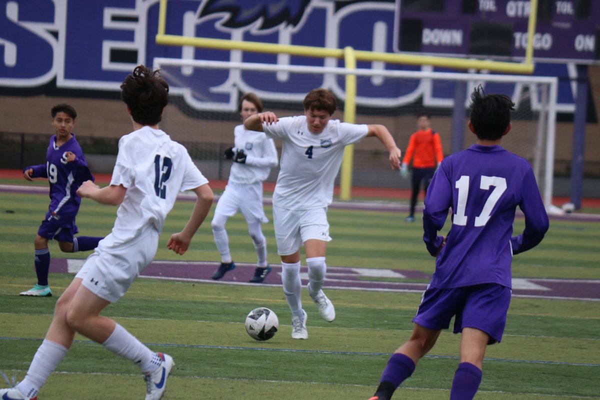Freshman Colin Delaney dribbles the ball in between two Ravens defenders. He passed the ball to one of his teammates, leading to a shot on goal. The Scots defense played well throughout the game and managed to stop most of the Ravens scoring opportunities. 