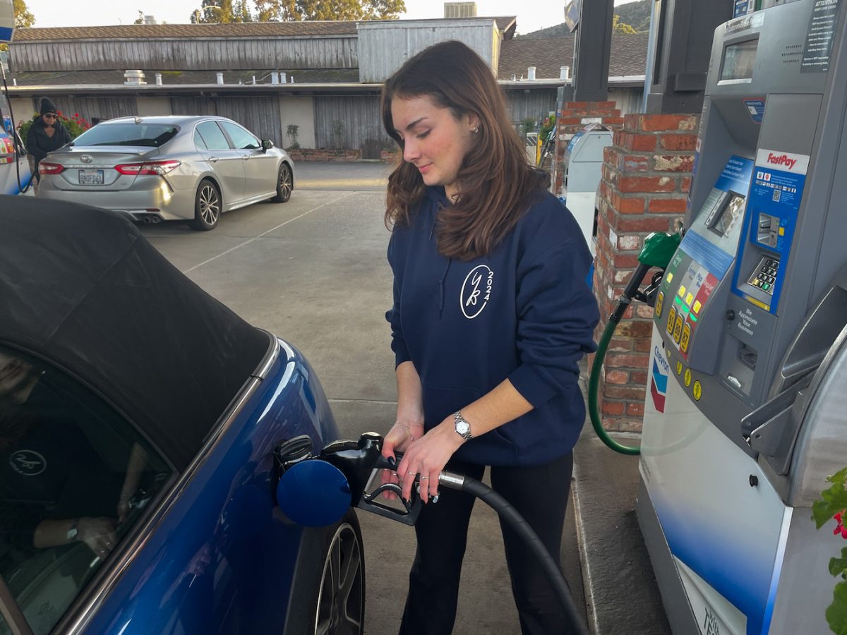 A person pumps gas at a local gas station. As the price of clean energy goes up, the incentive to switch to electricity goes down. “If you make the cost of cleaner energy higher than the cost of fossil fuels, people aren’t going to want to switch to electric,” said Mark Toney, Executive Director at TURN, a consumer advocacy organization.