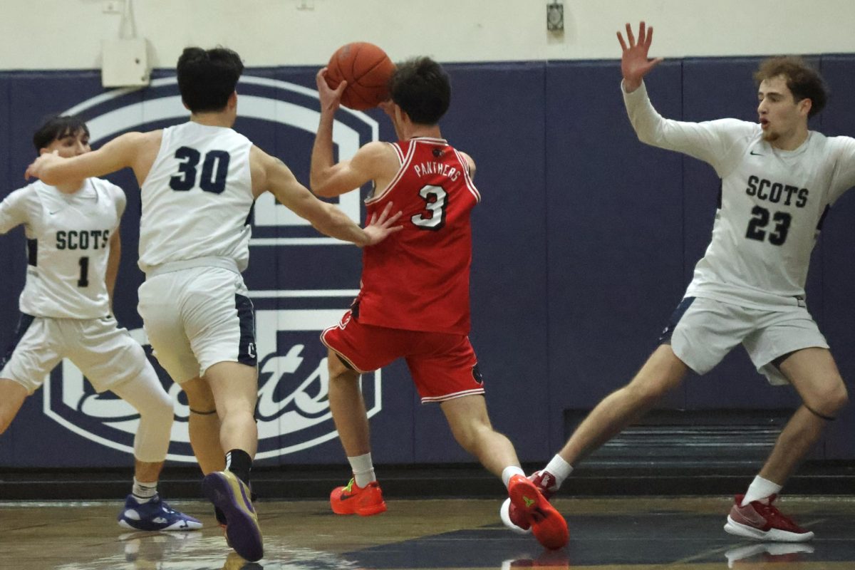 Burlingame senior Alain Kazarian breaks through Carlmonts defense and drives toward the basket for a hook shot. Kazarian beats Jacob Magpayo in a one-on-one, opening up a lane to the basket. Scots defenders crowded the path to the hoop, but could not stop the Panthers from scoring.