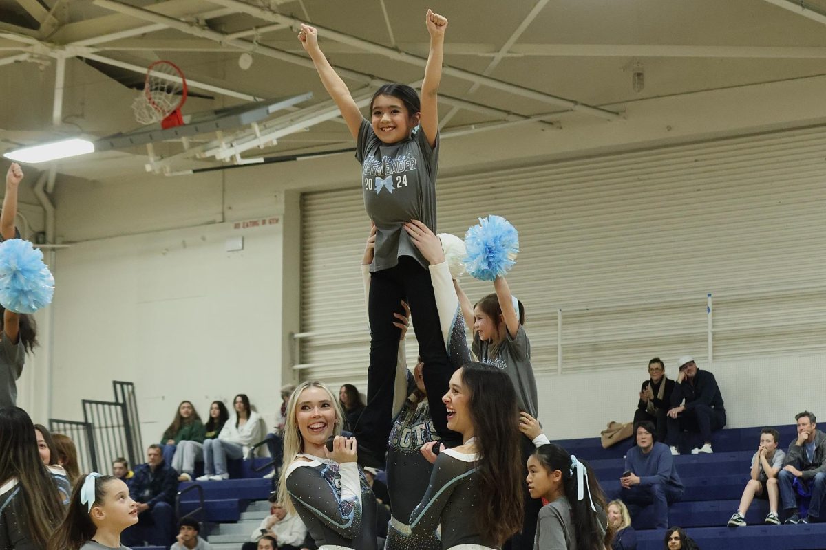The Carlmont cheer squad and their mini-cheerleaders perform their dance and stunts for the crowd during halftime. Spreading Carlmont spirit from small to tall, the Scots fill the room with laughs and smiles. Enthusiasm from the crowd carries over into the second half as fans continue to cheer on the Scots.
