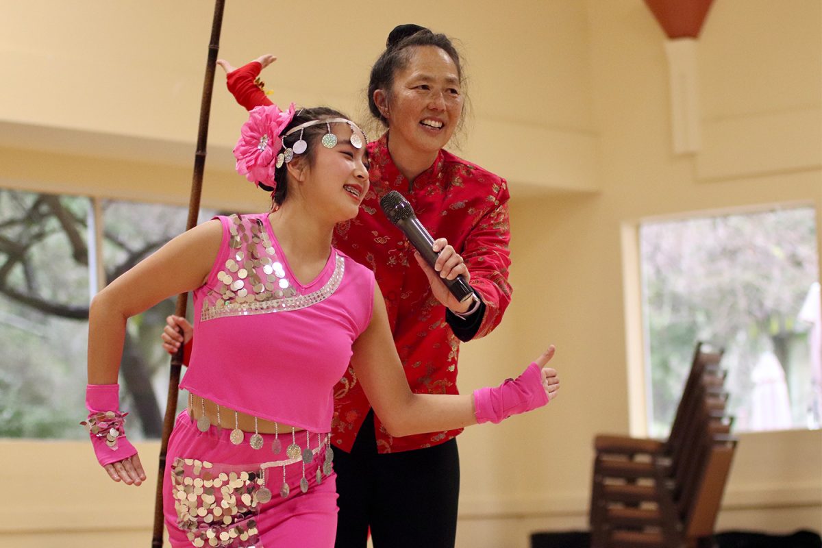 Kim Quon, a manager of the Flying Angels Chinese Dance Company, interviews a dancer in her ending pose of a trio performance called One River Three Ways. The Lunar New Year Celebration at Twin Pines Senior and Community Center began with performances by the Flying Angels. Quon announced each performance to the audience.