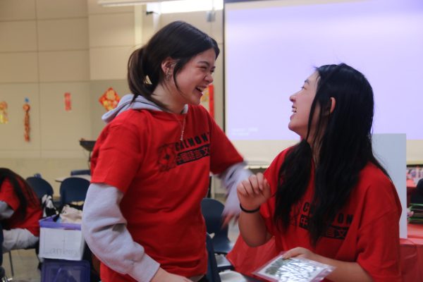 Jasmine White and Leah Wong, student volunteers at the event, partake in the Lunar New Year activities. 