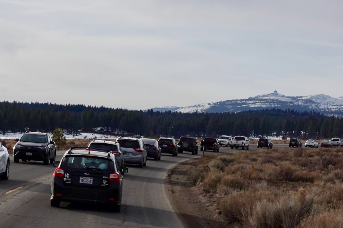 A line of cars stand in traffic on their way to Lake Tahoe, as they release carbon emissions.