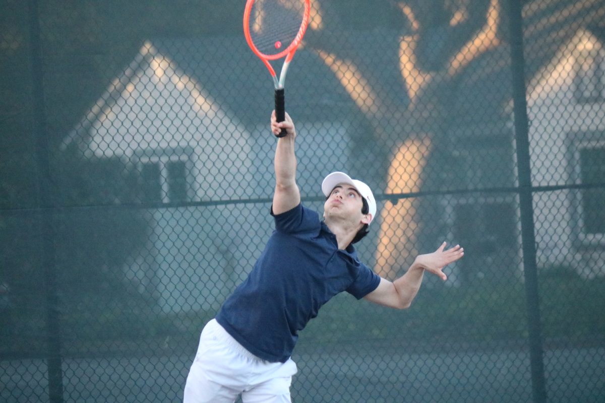 Senior Jacob Yuryev strikes the ball during the match point. Throughout the game both teams played fiercely. However, nearing sunset, the game was officially ended early due to environmental challenges. In the end, Carlmont finished victorious even with an unfinished game. 