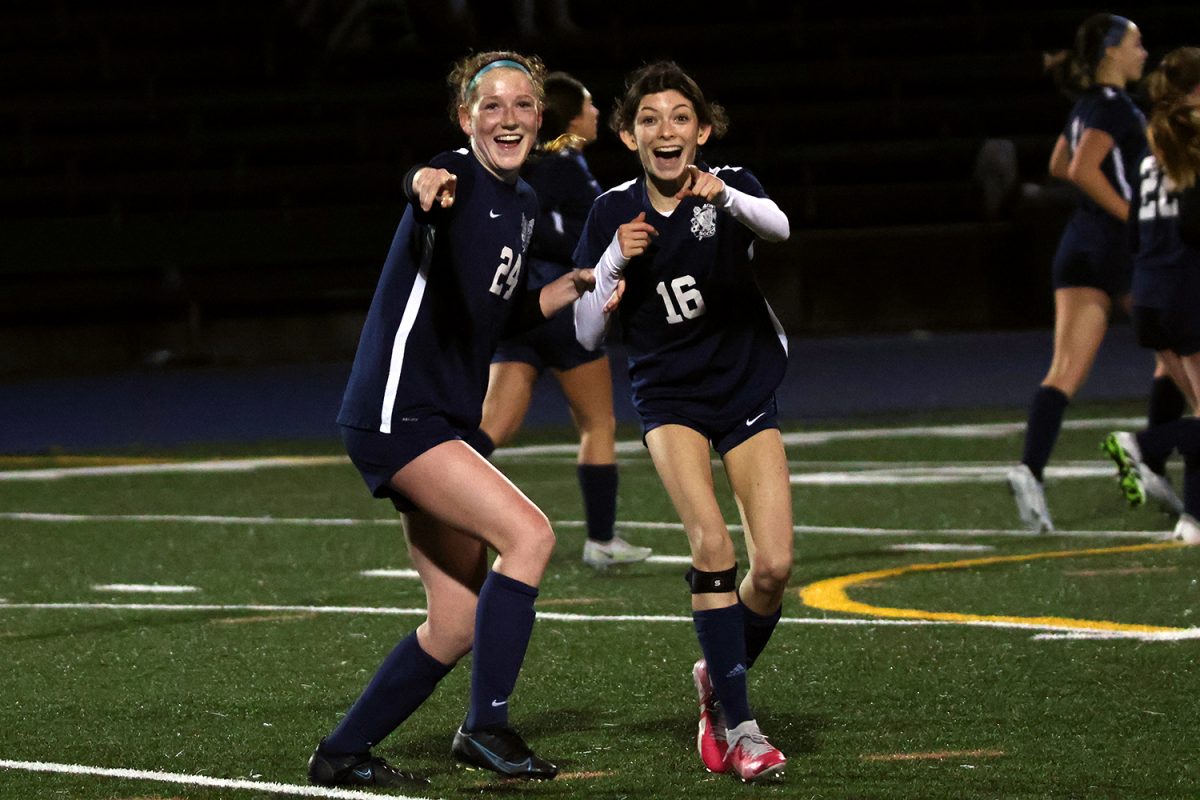 After her goal, Kumer celebrates with her teammate, Mara Baga. When the referee called a foul in the box, Kumer stepped up to take the penalty kick. The Scots put themselves ahead of the Ravens 3-1 with a successful, composed shot.