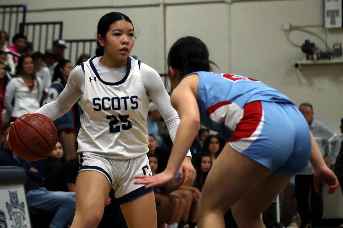 Junior Willow Ishibashi-To dribbles while looking for an opportunity to run toward the hoop. Ishibashi-To made many drives into the key, weaving through Hillsdale’s defense. Ultimately, she added 10 points to Carlmonts score through a combination of layups and 3-point shots.