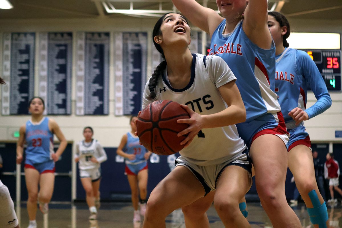 Freshman Sky Yee looks up at the hoop, preparing to spin away from the defender. Hillsdale locked down on a few counterattacks, forcing Carlmont’s offense to be creative. Yee scored eight points during the game, all of which were 2-pointers.