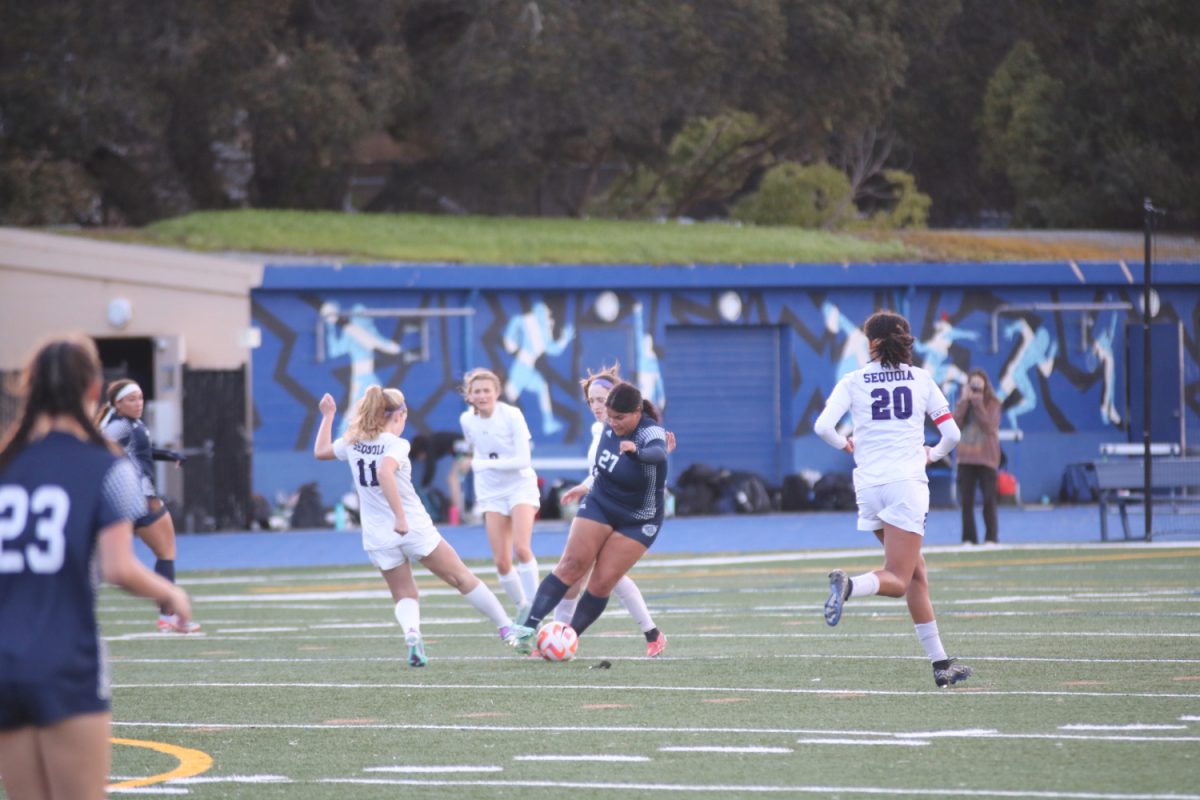 Senior Thais Nunez clashes with a Sequoia midfielder. She was able to earn possession of the ball and then pass it to one of her teammates. Nunez later scored Carlmonts only goal of the game.