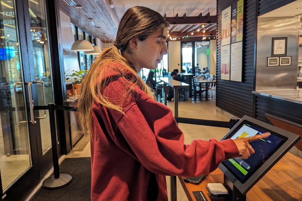 A Shake Shack customer uses one of the six iPads they provide as an alternative to ordering at the counter. Many fast food restaurants have implemented similar technology, like McDonalds. 