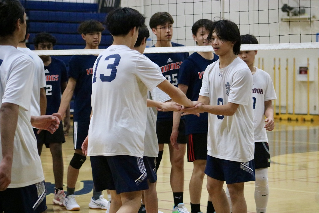 Sophomore opposite hitter Euclid Wong stands by the net to high-five his teammates before the game starts. During the game, he made passes, played right-back defense, and hit the ball out of the back row. Even in the moments when he stood on the sidelines, he kept his energy high and was enthusiastically cheering for his teammates efforts on the court.