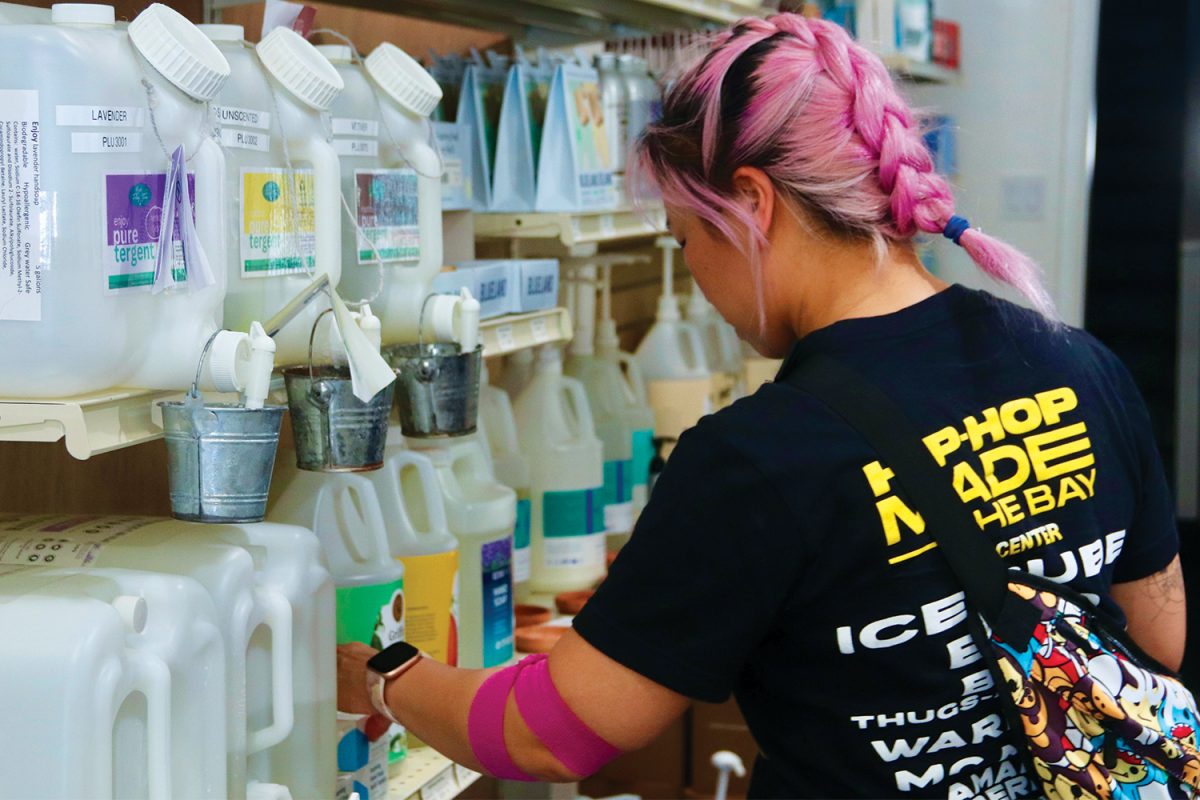 A first-time customer browses through the soap in the self-care aisle. She was curious about the solid soap tablets and discovered that one tablet dissolved in water could make nine ounces of liquid soap. The store offers customers a variety of soaps from different brands that uphold similar values of sustainability.