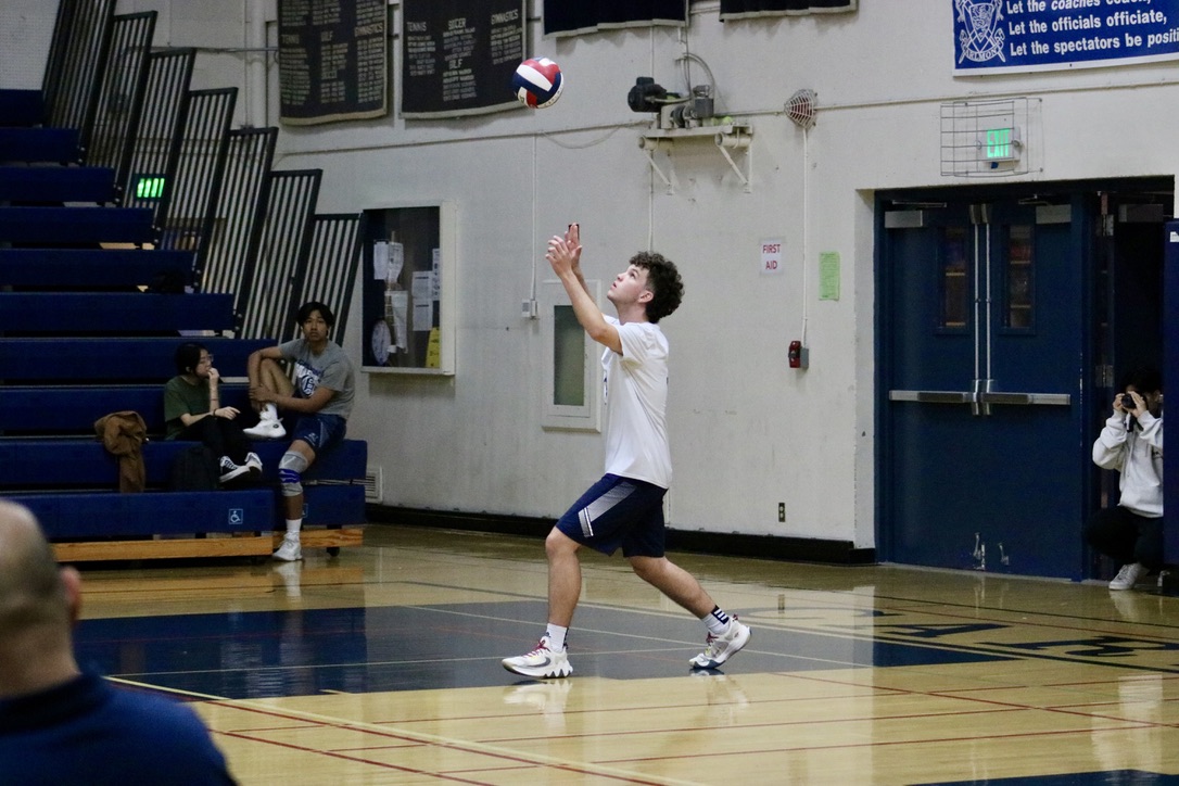 Sophomore Mateus Lima Duvai tosses the ball when preparing to serve. In this serve, Duvai performed an overhand serve, and didnt jump like one does for a jump serve or a jump float serve. He is a middle hitter for the Scots and was a key player because he was constantly moving around the court to block, pass, and hit the ball. 