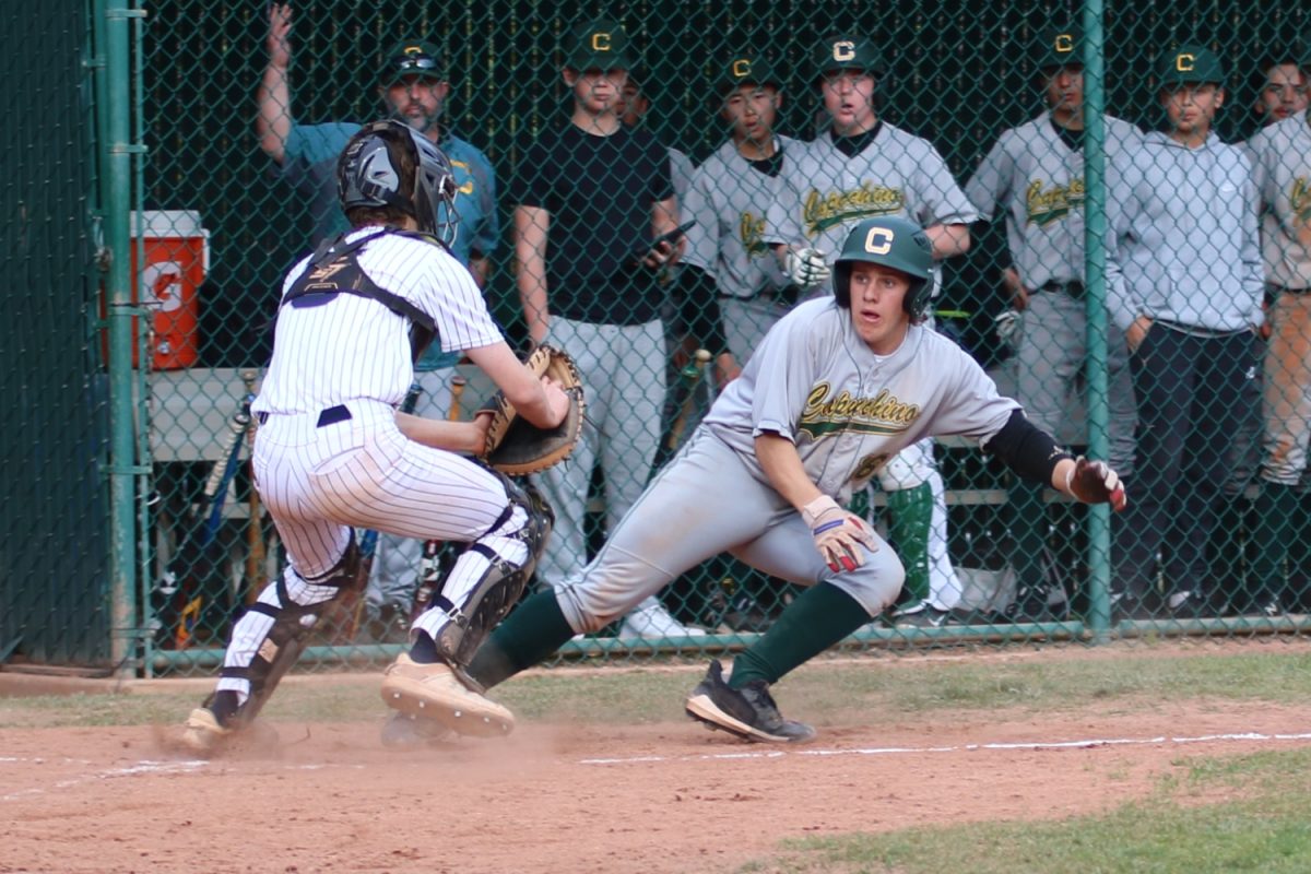 Sophomore catcher Ben Taylor tags out a Capuchino runner trying to score. 
