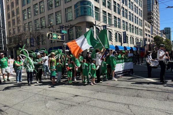 A member of the San Francisco Glens Soccer Club waves an Irish flag while marching through the parade.
