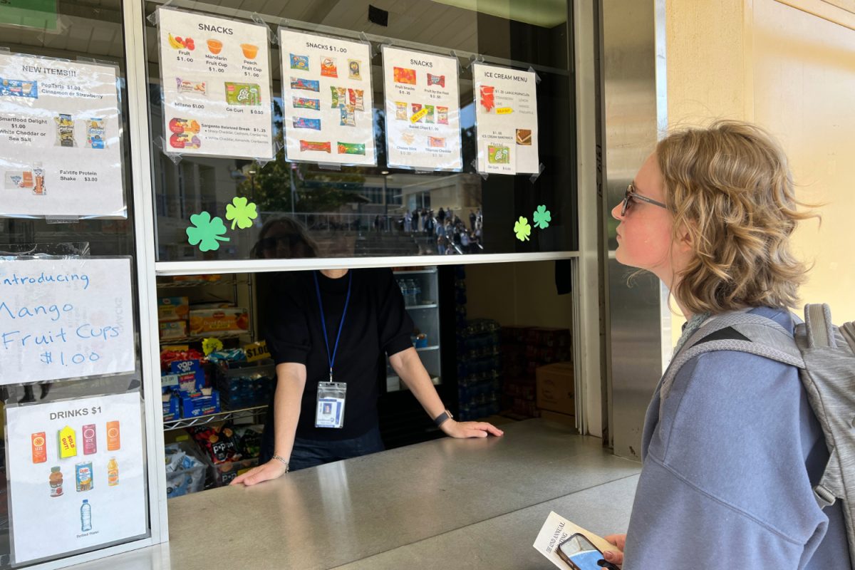 Carlmont senior Sam Dechaine scans the snack options available at the Student Store on campus. Several choices, including Go-Gurt, Goldfish, and Pop-Tarts, contain synthetic dyes. “We should make snacks seem less processed and that includes taking out artificial food coloring and making them feel more natural,” Dechaine said.