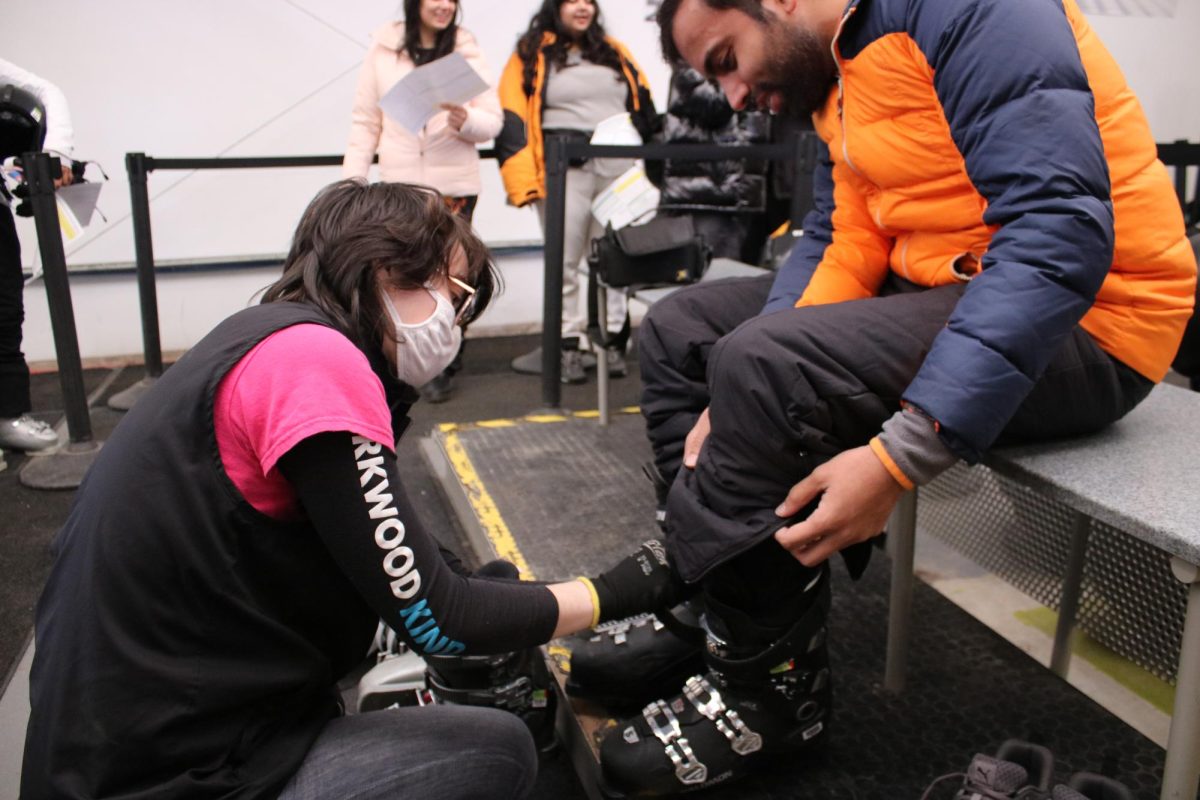Rental associate Leigh Almodovar adjusts a first-time skiers boots to ensure comfort on the slopes. 