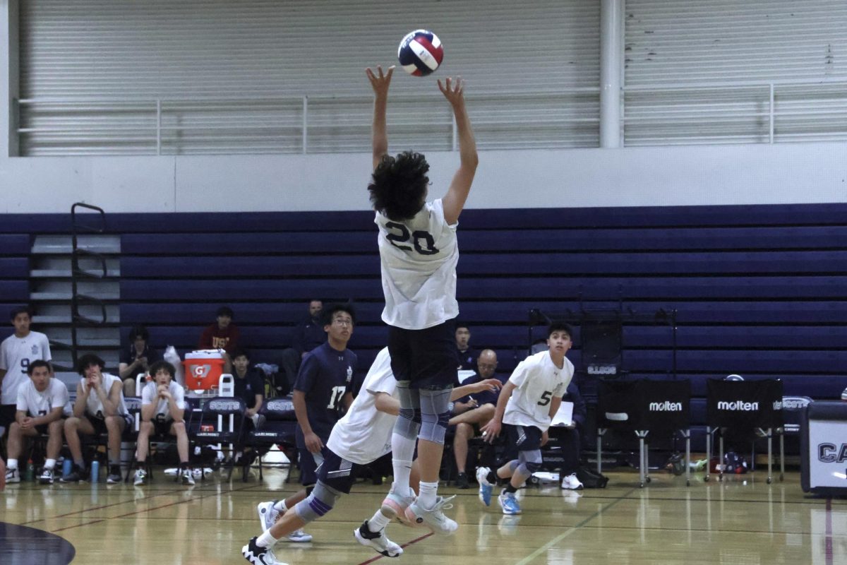 Freshman Tyler Louie sets the ball. His teammates quickly step forward, preparing to spike the ball as they anticipate where it will go. Louie played a strong offensive and defensive game, earning many points and blocks. 